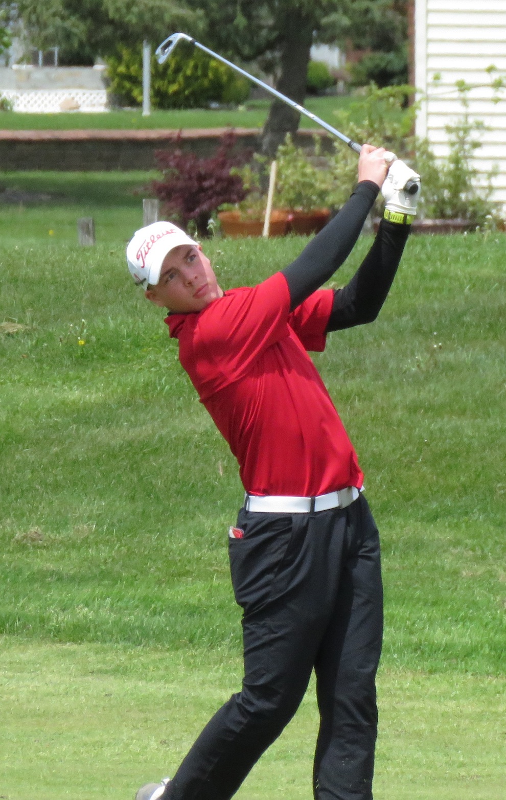 Anthony Delisanti hits an approach shot during Monday's Section VI tournament. (Photo by David Yarger)